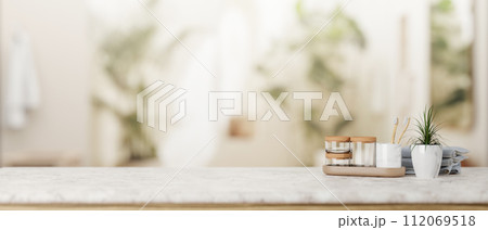 A presentation space for display product on a white marble tabletop in a modern, luxurious bathroom. A presentation space for display product on a white marble tabletop in a modern, luxurious bathroom. 112069518