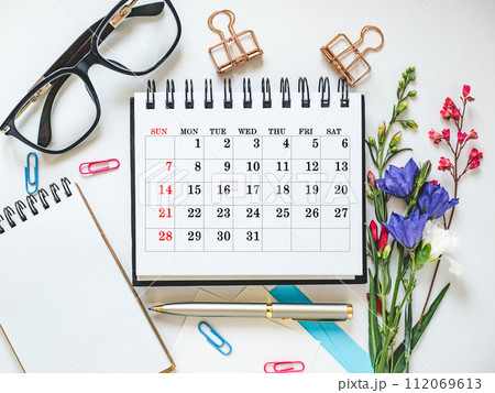 Calendar lies on the table in the office 112069613