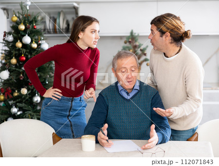 Adult children argue with each other and show their mature father how to fill out documents correctly Adult children argue with each other and show their mature father how to fill out documents correctly 112071843