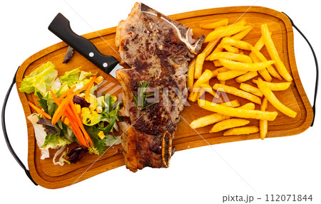 Beef served with potatoes and vegetable salad 112071844