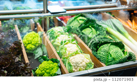Large assortment of freshly harvested organic vegetables showcased in supermarket Large assortment of freshly harvested organic vegetables showcased in supermarket 112071903
