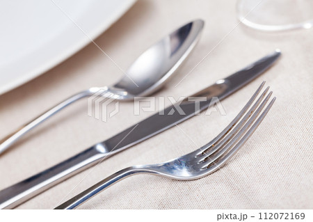 Fork lies on served table with cutlery 112072169