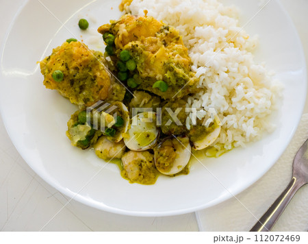 Dish from chef - stewed large piece of monkfish, garnished with boiled rice, quail eggs, green peas Dish from chef - stewed large piece of monkfish, garnished with boiled rice, quail eggs, green peas 112072469