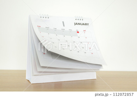 Calendar page flipping sheet on wood table background business schedule planning appointment meeting concept 112072857