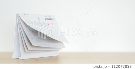 Calendar page flipping sheet on wood table background business schedule planning appointment meeting concept Calendar page flipping sheet on wood table background business schedule planning appointment meeting concept 112072858