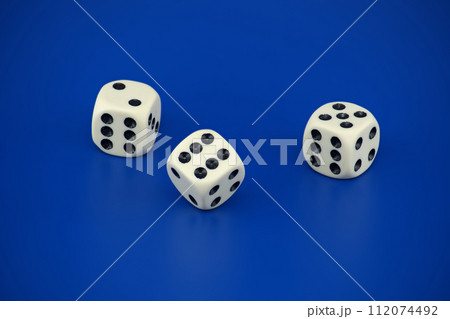 Gaming scene with three dice on blue background 112074492