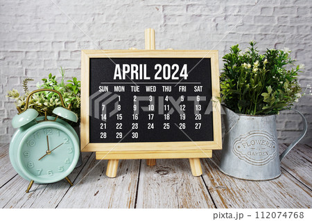 April 2024 monthly calendar and alarm clock on wooden background April 2024 monthly calendar and alarm clock on wooden background 112074768