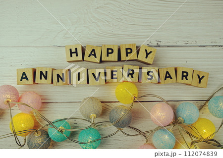 Happy Anniversary alphabet letters with LED cotton balls decoration on wooden background Happy Anniversary alphabet letters with LED cotton balls decoration on wooden background 112074839