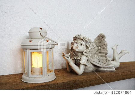 White lantern and Fairy statue Home decoration accessories on wooden shelves 112074864