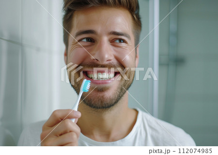 a man holding toothbrush and smiling with beautiful teeth bokeh style background with generative ai 112074985