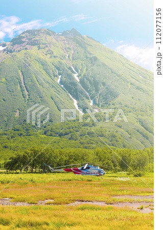Helicopter on Khodutka Volcano. South Kamchatka Nature Park on sunlight 112077156