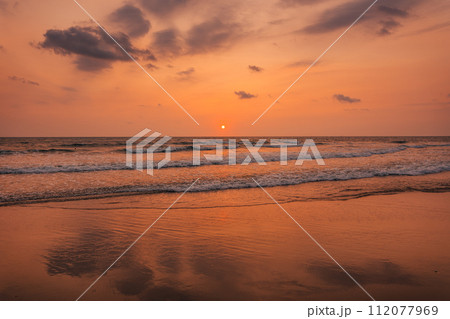 Sunset on the beach and orange sea waves Sunset on the beach and orange sea waves 112077969