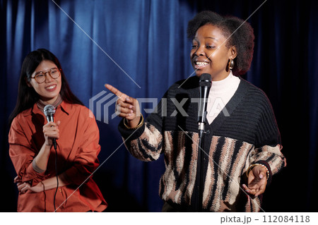 Young comedian pointing at audience 112084118
