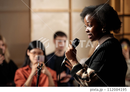 Woman performing in front of audience 112084195