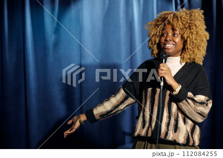 Young smiling female stand up comedian Young smiling female stand up comedian 112084255