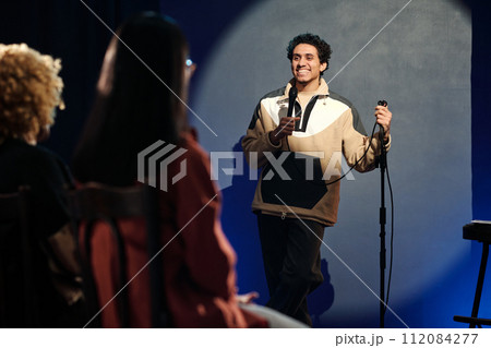 Young male comedian talking to audience Young male comedian talking to audience 112084277