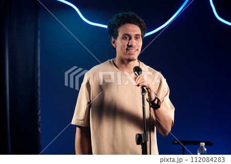Young male comedian in beige t-shirt Young male comedian in beige t-shirt 112084283