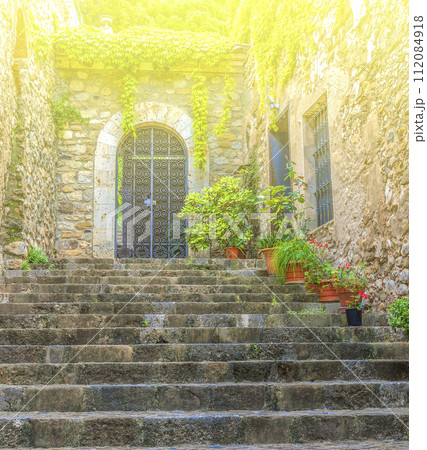 Stone steps to the door of the old house on sunlight 112084918