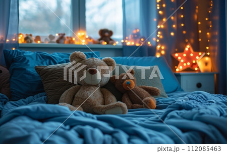 a blue bed with decorative pillows, stuffed animals and lights a blue bed with decorative pillows, stuffed animals and lights 112085463