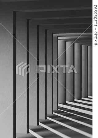A black and white background with light coming through the building structure. A black and white background with light coming through the building structure. 112086592