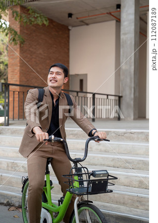 The businessman eco friendly transportation, cycling through the city avenues to go to work. sustainable lifestyle concept 112087189