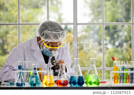 One Scientist conducting microscopic analysis in lab; Precision and Inquiry in Scientific Analysis 112087413