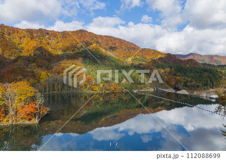 日本　青森県中津軽郡の大川白神橋から見えるの暗門川と鏡面に映った紅葉 112088699