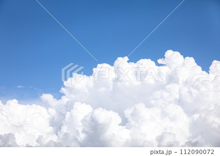 Huge white cumulus cloud against blue sky Huge white cumulus cloud against blue sky 112090072