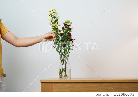 Woman hand arrange Colorful flowers bouquet in mason jar on table background. Happy day with fresh flower Woman hand arrange Colorful flowers bouquet in mason jar on table background. Happy day with fresh flower 112090373