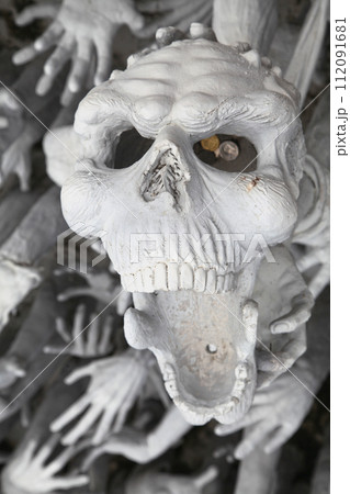 Skull from hell at Wat Rong Khun in Chiang Rai 112091681