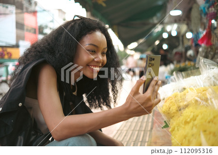 Asian woman enjoy travel in  downtown district 112095316