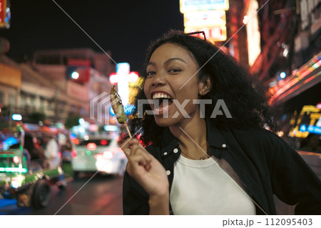 Asian woman enjoy travel in  downtown district 112095403