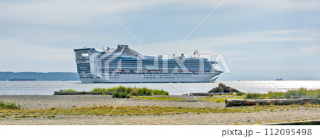 White ocean cruise liner passing by Burrard inlet in Vancouver, Canada 112095498
