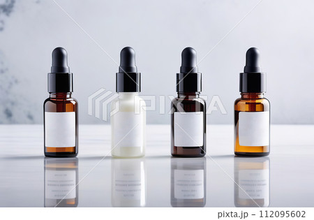 Blank Cosmetic dropper bottle set with transparent fluid oil template. Oily pipette pump packaging mock up with empty label. Skin care products. Arranged in a row. Marble white background. No people Blank Cosmetic dropper bottle set with transparent fluid oil template. Oily pipette pump packaging mock up with empty label. Skin care products. Arranged in a row. Marble white background. No people 112095602