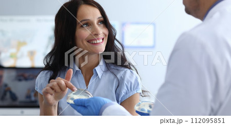 Woman touching implants Woman touching implants 112095851