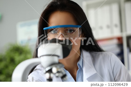 Beautiful mature assistance using scientific microscope Beautiful mature assistance using scientific microscope 112096429