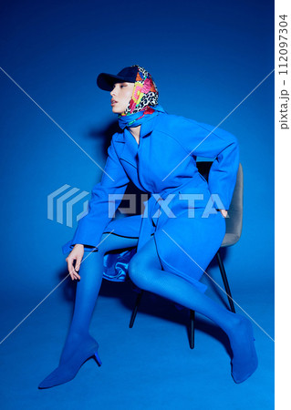 fashion portrait of young elegant woman in blue coat. fashion portrait of young elegant woman in blue coat. 112097304
