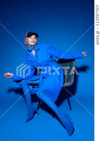 fashion portrait of young elegant woman in blue coat. 112097307