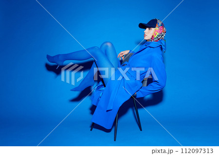 fashion portrait of young elegant woman in blue coat. fashion portrait of young elegant woman in blue coat. 112097313