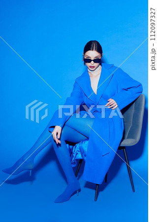 fashion portrait of young elegant woman in blue coat. 112097327