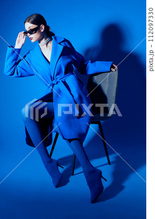 fashion portrait of young elegant woman in blue coat. 112097330