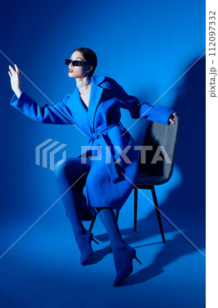 fashion portrait of young elegant woman in blue coat. fashion portrait of young elegant woman in blue coat. 112097332