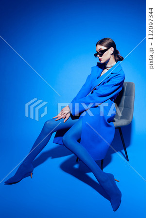 fashion portrait of young elegant woman in blue coat. fashion portrait of young elegant woman in blue coat. 112097344