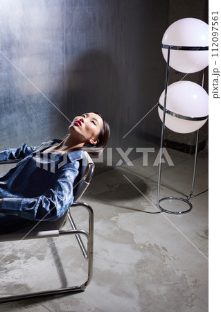 Fashion asian female model in blue glitter suit posing on metallic modern futuristic location. Fashion asian female model in blue glitter suit posing on metallic modern futuristic location. 112097561