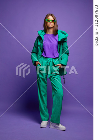 Fashion asian female model in green down jacket and pants. 112097683