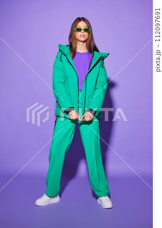 Fashion asian female model in green down jacket and pants. Fashion asian female model in green down jacket and pants. 112097691