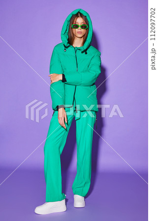 Fashion asian female model in green down jacket and pants. Fashion asian female model in green down jacket and pants. 112097702