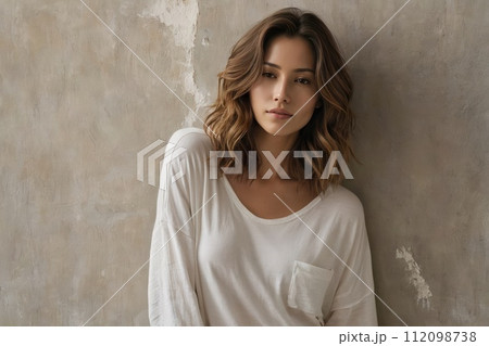 AI-generated content. Young pretty woman in white blouse stands and poses near an old shabby wall 112098738