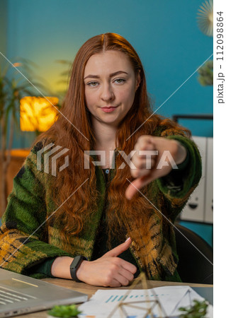Upset business woman freelancer working on laptop showing thumbs down sign disapproval dissatisfied Upset business woman freelancer working on laptop showing thumbs down sign disapproval dissatisfied 112098864