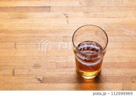 Craft beer in pint glass on a wooden table Craft beer in pint glass on a wooden table 112098969